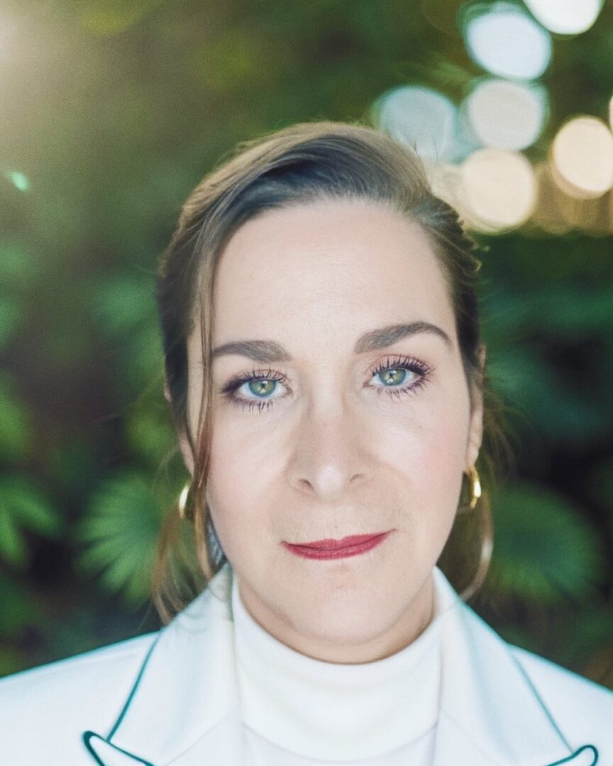 Woman with light makeup and greenery background